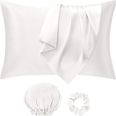 Set of white satin pillowcases, a bonnet, and a hair tie on a white background